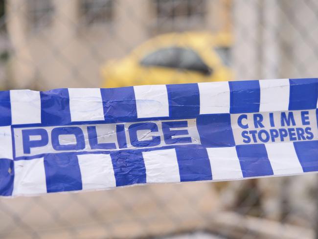 Blue and white Police tape cordoning off a area with a yellow car at a industrial area, Australia 2016 Police tape cordoning off a area with a yellow car - Stock image ipad generic