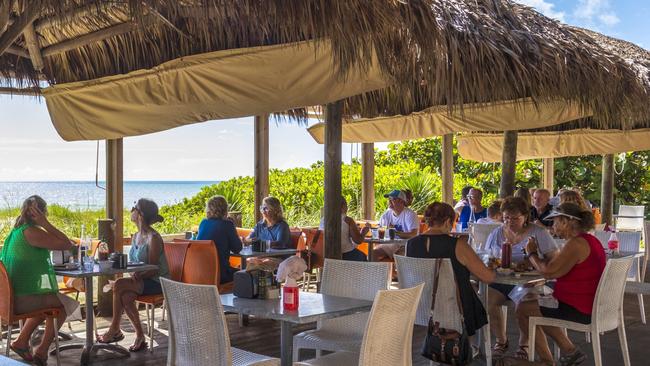 People dine at a restaurant on the beach in Melbourne, Florida, on Saturday. Picture: Saul Martinez