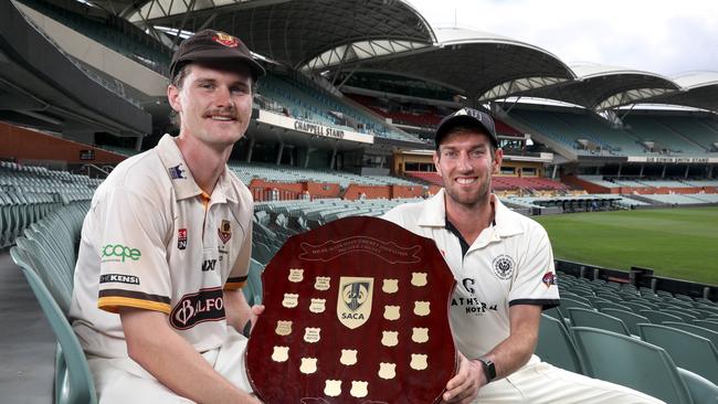 Kensington Captain, Josh Doyle, (L), and Adelaide University Captain, Will Bosisto, at Adelaide Oval with the Premier Cricket shield ahead of this weekend’s grand final. 30 March 2023. Picture: Dean Martin