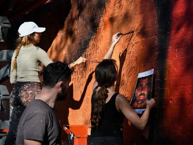 Artists paint a mural. Picture: AAP/Bianca De Marchi