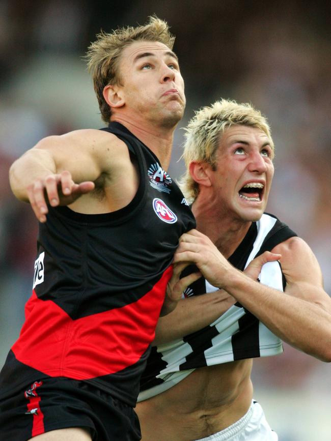 Aaron Henneman battles Collingwood forward Travis Cloke.