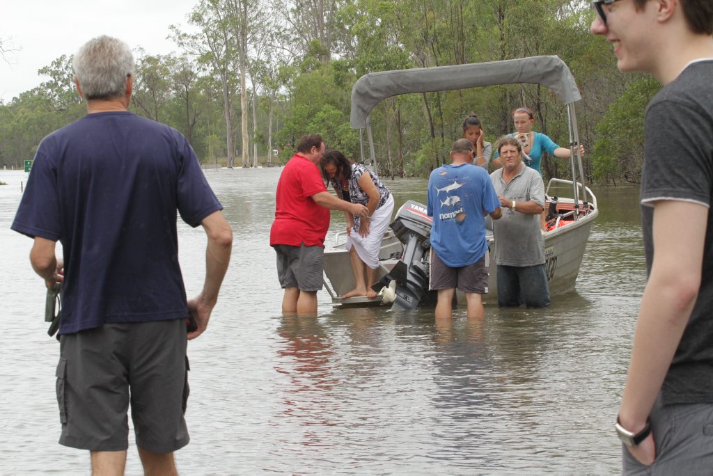 Rob Hart (front right) ferried stranded Aldershot residents who were stranded to the Maryborough side of the Bruce Highway. Photo: Robyne Cuerel / Fraser Coast Chronicle. Picture: Robyne Cuerel