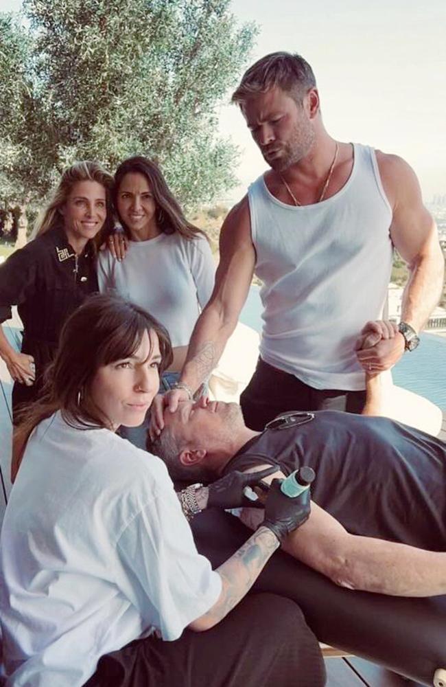 Chris Hemsworth holds Matt Damon's hand while the pair get tattooed together before the Oscars by artist Corina Weikl. Picture: Instagram