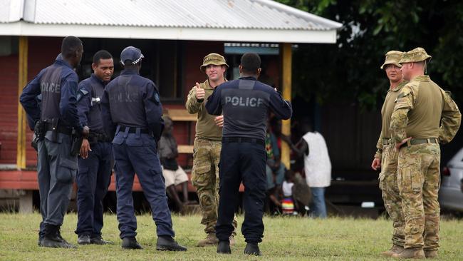 The ADF and AFP working together with counterparts from the Solomon Islands to improve border security and combat the movement of drugs about the Pacific. Here they talk tactics on Taro Island. Picture: Gary Ramage