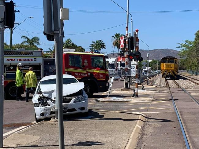 A car crash has blocked a busy intersection and halted a train this morning.