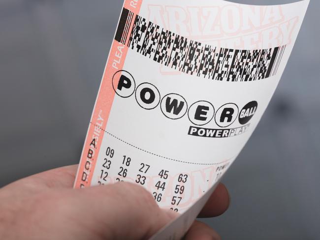 Kingman, USA - January 20, 2016: A photo of a man holding a Powerball lottery ticket in Kingman, Arizona.