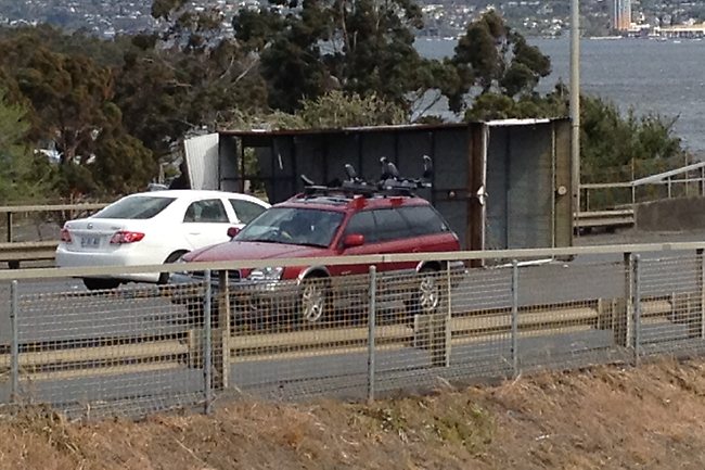 The back of a small rubbish truck blew off on the Tasman bridge creating traffic chaos for city-bound traffic.