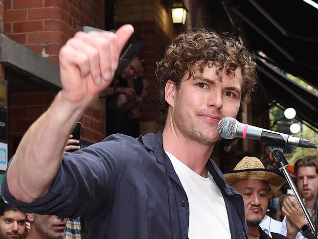 Vance Joy doing a pop up gig in Hardware Lane, Melbourne. A flower wreath was displayed and he dedicated his song Riptide to Michael Gudinski. Picture: Josie Hayden