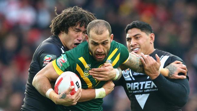 Blake Ferguson of Australia is tackled by Kevin Proctor and Jason Taumalolo.