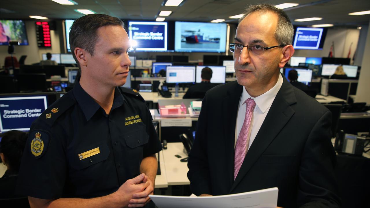 Mike Pezzullo, Secretary of the Department of Immigration and Border Protection, receives a briefing from Superintendent James Copeman in the Strategic Border Command Centre in Canberra. Picture: Ray Strange.