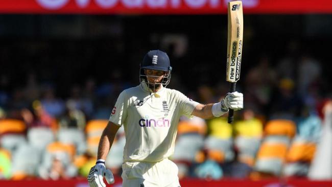 Joe root raises his bat after notching 50.