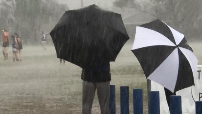 Rain falls during a junior football match at East Keilor on Sunday.