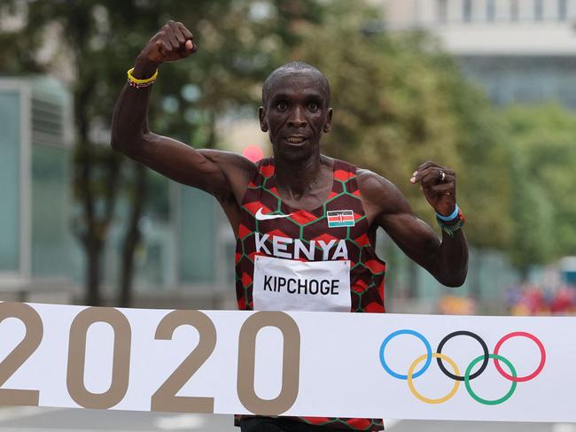 Kenya's Eliud Kipchoge crosses the finish line to win the men's marathon.