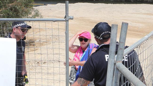 Black Swan Lake protest at Bundall goes to another level, with protesters chaining themselves to the fence and then getting themselves arrested after running onto the worksite and stopping the trucks. Protester Lindy Donato stopped the trucks after wandering onto the worksite, before being escorted to the Paddy wagon. Picture Glenn Hampson