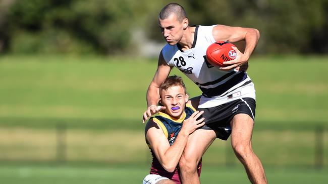 Zac Young tries to bring down Joel Fitzgerald. Picture: Steve Tanner