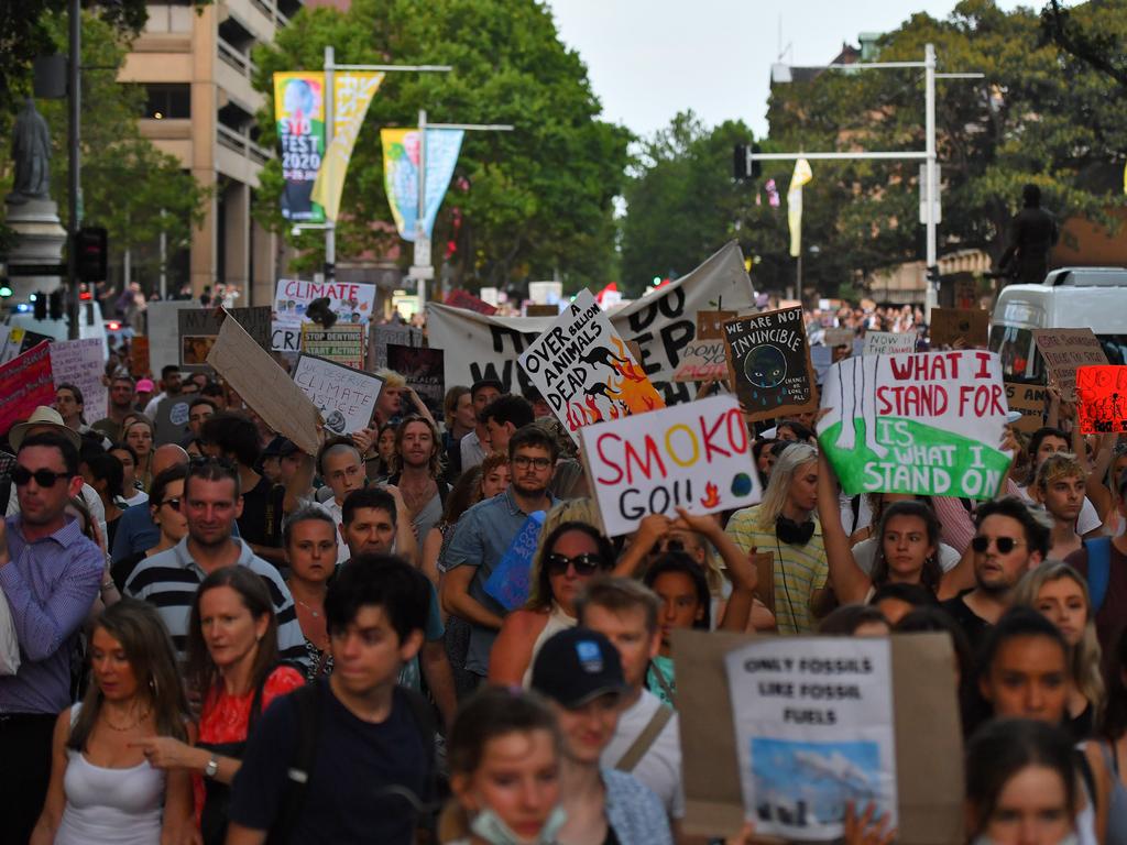 Protesters march with placards during a 'Sack ScoMo!' climate change rally in Sydney, Friday, January 10, 2020. (AAP Image/Steven Saphore)