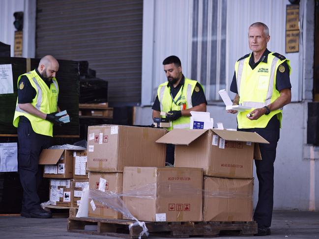 Australian Border Force officers inspecting a shipment of vapes suspected of containing nicotine. Picture: Sam Ruttyn