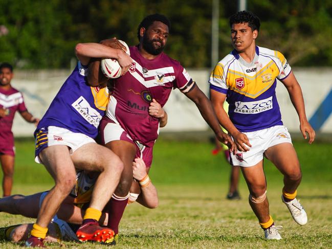 Yarrabah's Samukie Gaidan is tackled by Edmonton defenders.