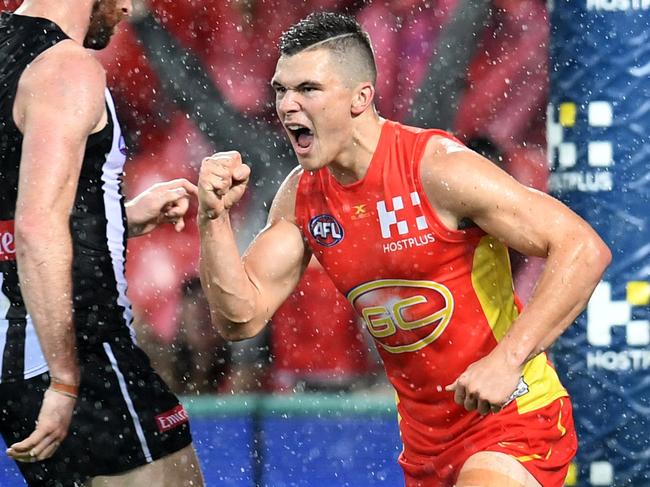 Ben Ainsworth of the Gold Coast Suns (right) celebrates scoring a goal during the Round 17 AFL match between the Gold Coast Suns and the Collingwood Magpies at Metricon Stadium on the Gold Coast, Saturday, July 15, 2017. (AAP Image/Dan Peled) NO ARCHIVING, EDITORIAL USE ONLY