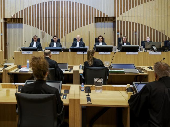 Presiding judge Hendrik Steenhuis, rear, fourth from left, opens the court session as the trial into the downing of flight MH17 continued. Picture: AP