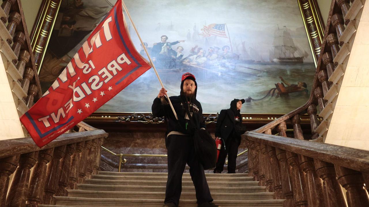 A protester holds a Trump flag inside the US Capitol Building. Picture: Win McNamee/Getty/AFP