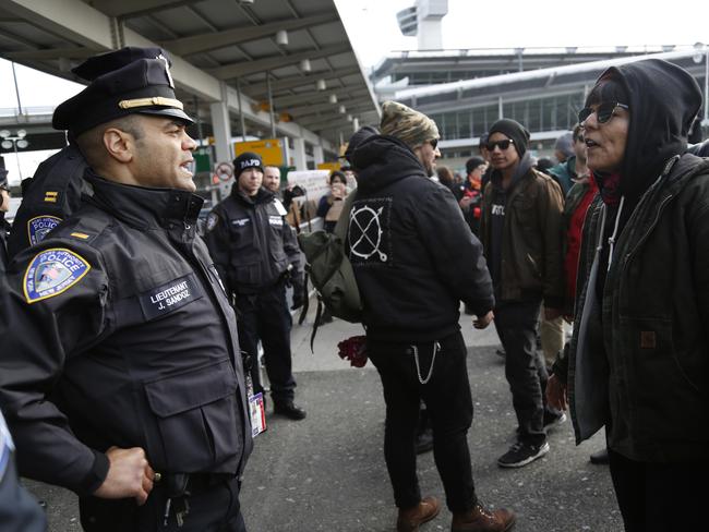 Port Authority police stand in front of protesters at John F. Kennedy International Airport in New York. Picture: AP