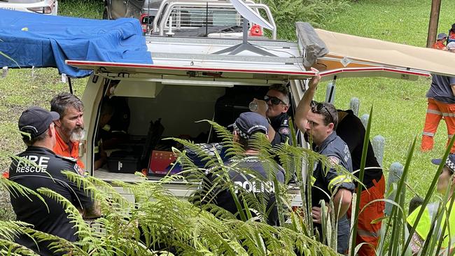 Emergency crews plan the extraction of a deceased kayaker's body from a dangerous section of the South Johnstone River. Picture: Alison Paterson