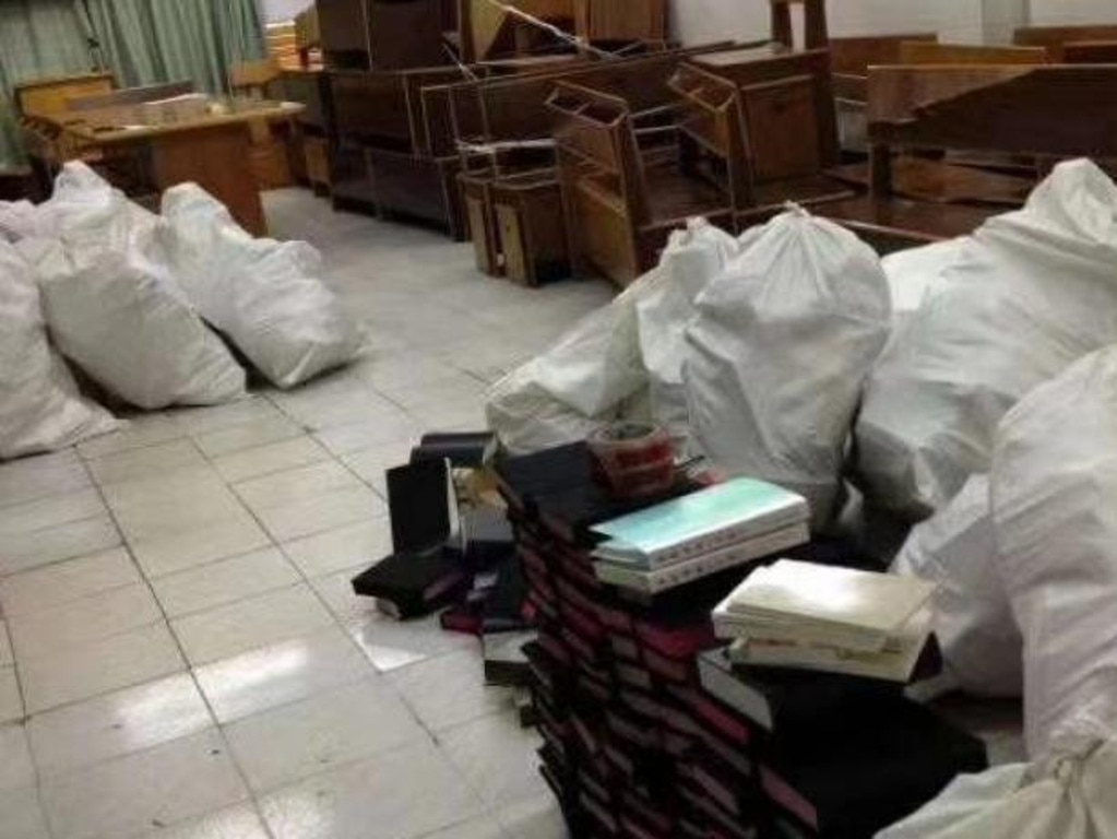 An image from Chinese social media showing bundles of books and documents being gathered by police after a raid on a Chinese protestant church.