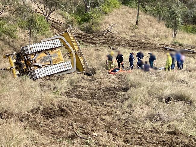 Man flown to hospital after bulldozer rolls down embankment