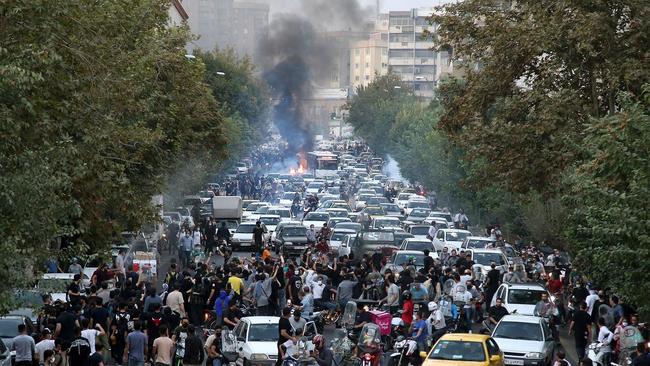 A motorcycle on fire during protests in Tehran on Saturday.