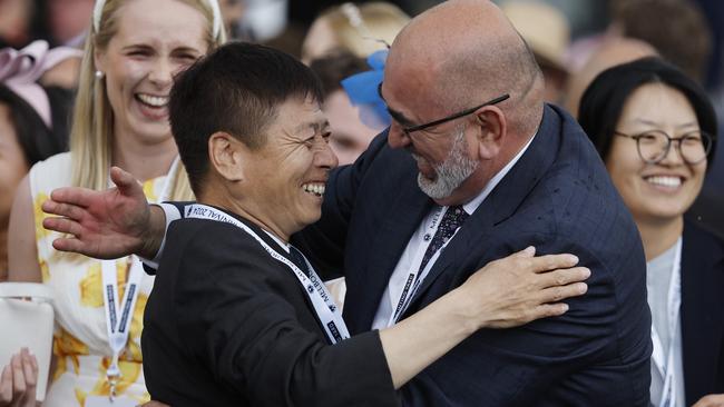 Yulong Stud owner and founder Yuesheng Zhang embraces his chief operating officer, Sam Fairgray, after Treasurethe Moment’s VRC Oaks victory on Thursday. Picture: Michael Klein