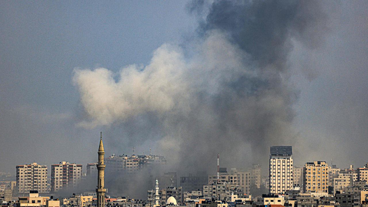 A plume of smoke rises above buildings in Gaza City during an Israeli air strike. Picture: AFP