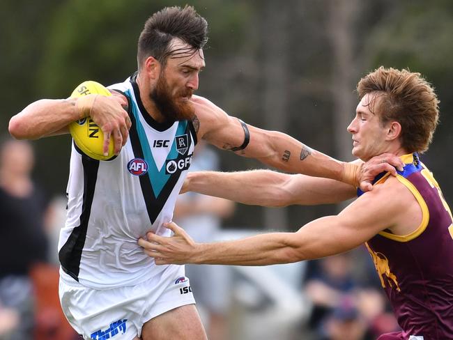 Charlie Dixon (left) of the Power is tackled by Harris Andrews (right) of the Lions during the AFL Marsh Community Series pre-season match between the Brisbane Lions and the Port Adelaide Power at the Moreton Bay Central Sports Complex in Burpengary, Queensland, Sunday, February 23, 2020. (AAP Image/Darren England) NO ARCHIVING, EDITORIAL USE ONLY