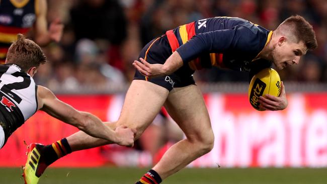 Crows  Bryce Gibbs is tackled by Port Adelaide’s Tom Jonas at the Adelaide Oval. Picture: James Elsby/Getty