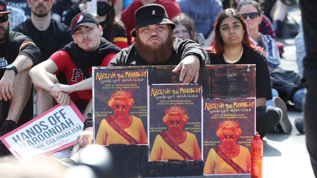 People at the Melbourne rally held signs which said to “abolish the monarchy”. Picture: NCA NewsWire / David Crosling