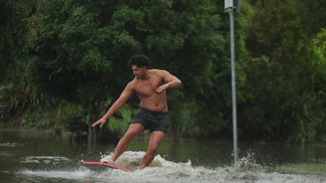 Paeroa Paul has fun in the floodwaters at Flooded Gum Park at Pacific Pines. Picture: Glenn Hampson.