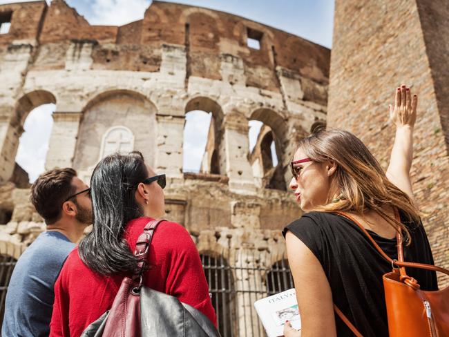 Tourists with a guide in front of the Coliseum, Rome