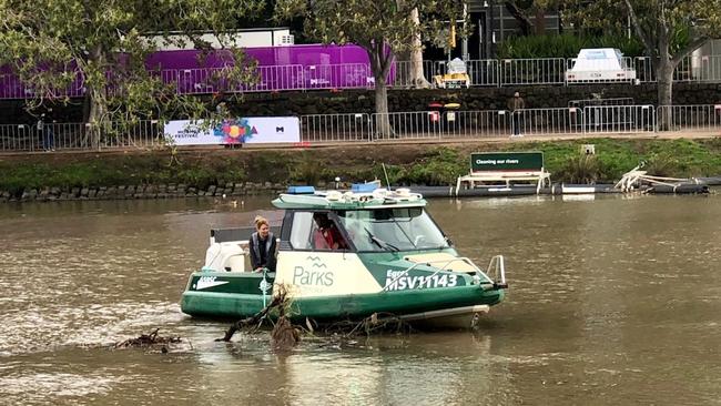 Parks Victoria officers clear the Yarra River of debris after the rain.