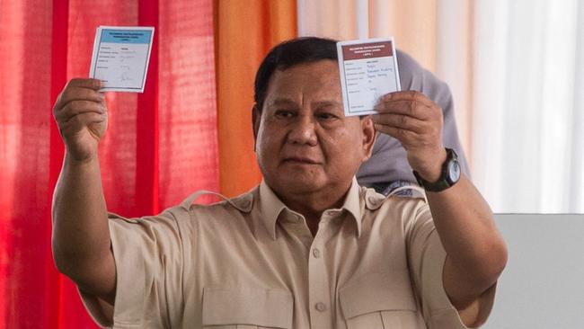 Indonesian President Prabowo Subianto shows the ballot papers while voting in Bogor, West Java on Wednesday. Picture: AFP