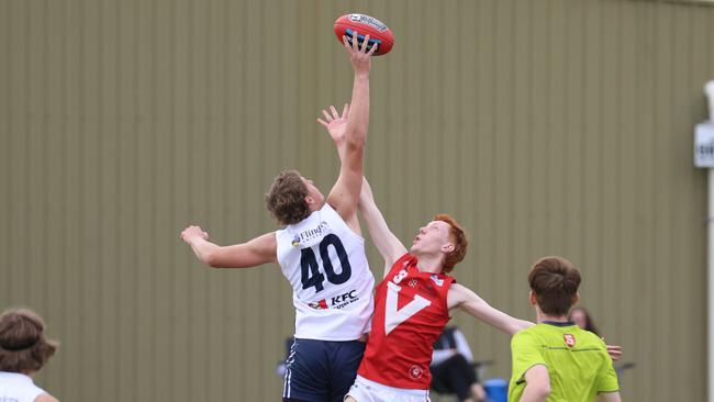 North’s Darcy Kelly and South’s Tom Schirmer contest the bounce in the under-16 semi-final. Picture: Russell Millard