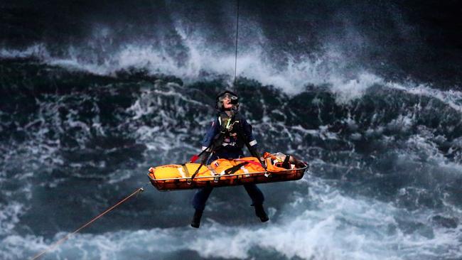 Blake Hayes is air lifted from the cliff base at Warriewood. Picture: Adam Ward