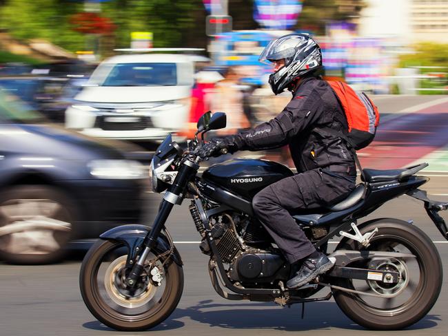 Sydney, Australia - December 28, 2016: A man commutes across the city centre on a motorbike in the morning rush hour. Panning has blurred the background.  - picture istock