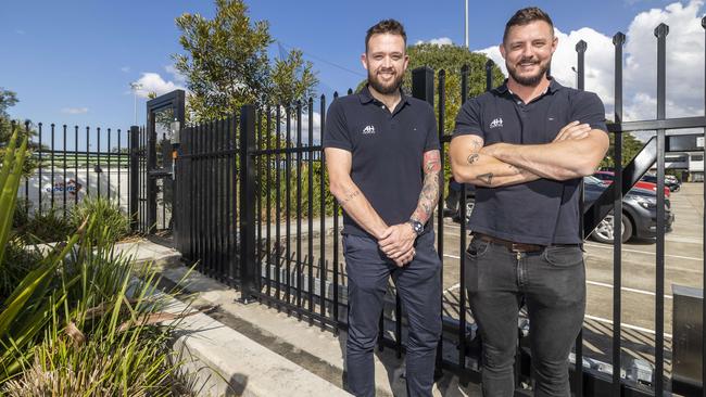 Directors of AH Fencing Matt Carroll and Adam Hall and at an Energex depot where they installed special fencing around the property.