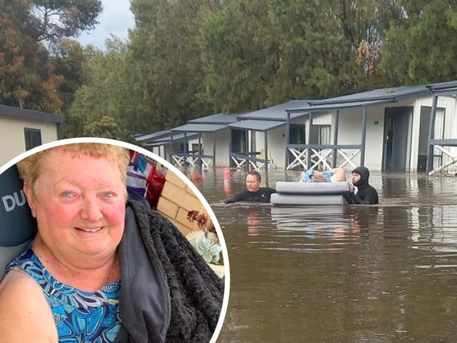 Helen Schluz being rescued after floods at Middleton Caravan Park.