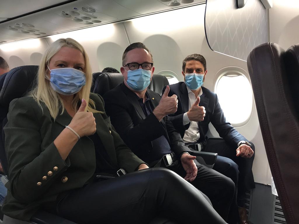 Qantas chief customer officer Steph Tully, Qantas chief executive Alan Joyce and Qantas International chief Tino La Spina wear masks on a recent flight.