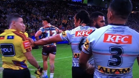 Jarome Luai appears to shove NRL touch judge Chris Sutton, before patting him to apologise.