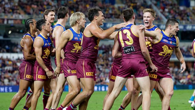 The Lions all get around Logan Morris after he kicked his first AFL goal. (Photo by Russell Freeman/AFL Photos via Getty Images)