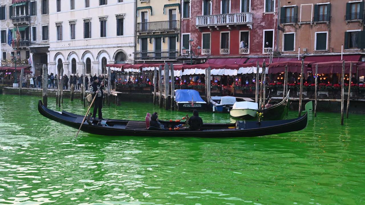 A gondola cruises on the Grand Canal after Extinction Rebellion activists dyed the water. Picture: Marco Sabadin / AFP