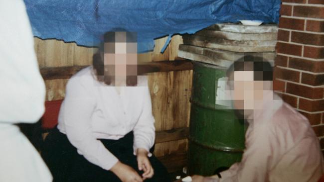 Unwitting guests at a party pictured with the green barrel in background holding Edwina Boyle’s body.