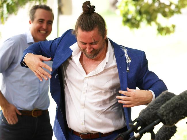 Sign language interpreter Mikey Webb gets covered in bird poo during a presser at flood damaged Kedron Brook cycleway, Lutwyche. Picture: Liam Kidston